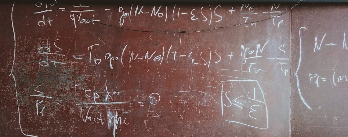 written equations on brown wooden board